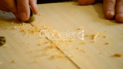 Luthier working with mini wood planer in guitar, close up