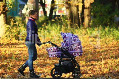 woman with perambulator in the park