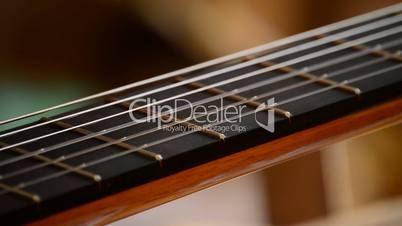 Playing the strings of a guitar, close up