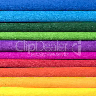 rolls of colored corrugated paper closeup on background