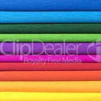 rolls of colored corrugated paper closeup on background