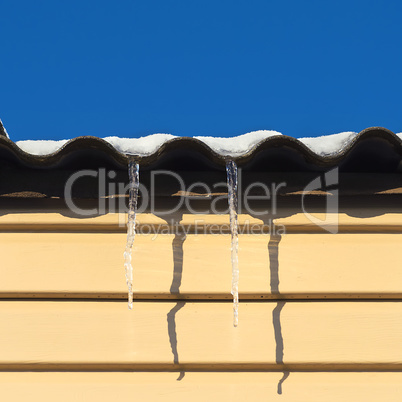 two icicles hanging from the roof