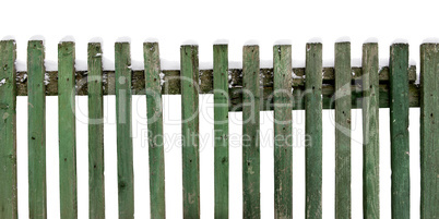 wooden fence covered with snow isolated on white background