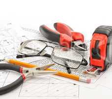 Tools and glasses on the drawing
