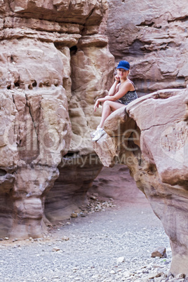 girl sitting on a rock