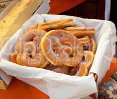 Basket of fried pretzel with sugar.