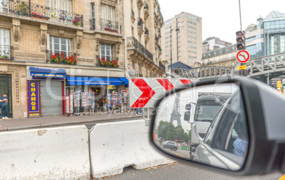 Leaving Paris by car. Eiffel Tower in the rear mirror