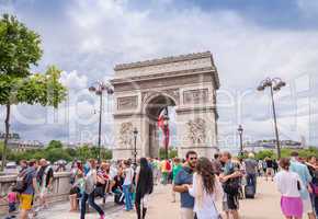 PARIS, FRANCE - JUNE 20, 2014: Tourists enjoy Triumph Arc view o