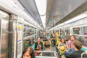 PARIS - JUNE 17, 2014: Tourists and locals on a subrway train. M