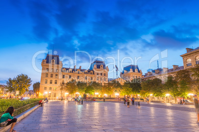 PARIS - JUNE 21, 2014: Tourists enjoy summer night lights in the