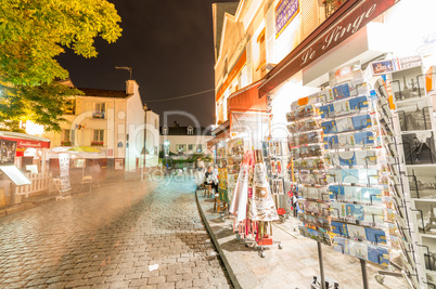 PARIS - JUNE 20, 2014: Tourists explore Montmartre streets at ni