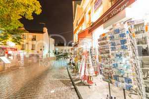 PARIS - JUNE 20, 2014: Tourists explore Montmartre streets at ni
