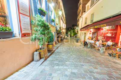 PARIS, FRANCE - JUNE 20, 2014: Tourists enjoy Montmartre city li