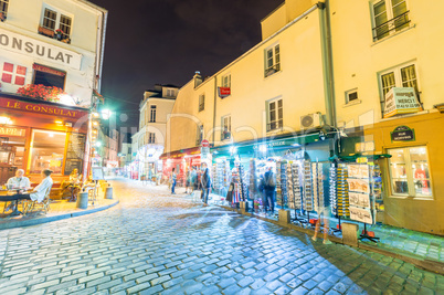 PARIS - JUNE 20, 2014: Tourists explore Montmartre streets at ni