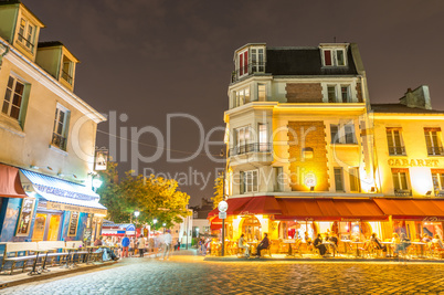 PARIS, FRANCE - JUNE 20, 2014: Tourists enjoy Montmartre city li