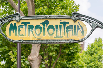 Metropolitain sign in Paris against trees