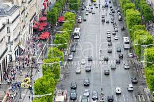 PARIS, FRANCE - JULY 20, 2014: Tourists walk along Champs Elysee