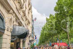 PARIS, FRANCE - JULY 20, 2014: Tourists walk along Champs Elysee
