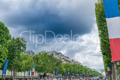 PARIS, FRANCE - JULY 20, 2014: Tourists walk along Champs Elysee