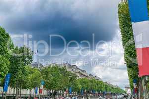 PARIS, FRANCE - JULY 20, 2014: Tourists walk along Champs Elysee