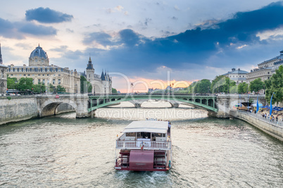 Parisian bateau on the Seine river at sunset