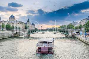 Parisian bateau on the Seine river at sunset