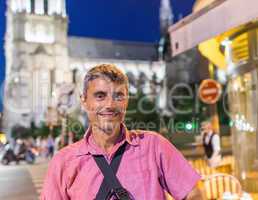 Happy male tourist in 40s enjoying Paris city life at night