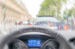 Blurred picture of fast moving car interior in city traffic