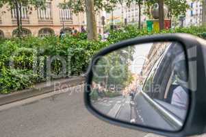Driving in a big city. Rear mirror view