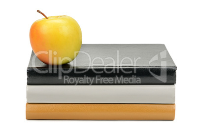 books and apple isolated on white background