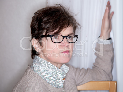 Woman looking critically out of the window