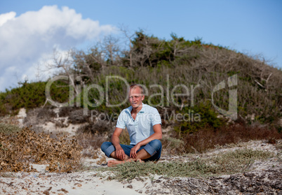 young man is relaxing outdoor in dune in summer