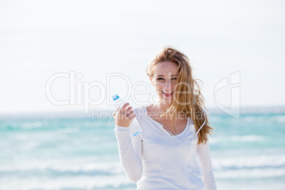 beautiful young woman drinking water in summer