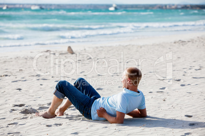 young man is relaxing on beach in summer vacation