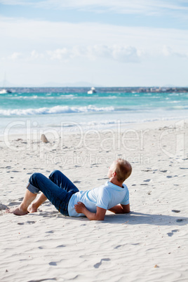 young man is relaxing on beach in summer vacation