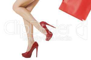 Woman Legs in Red High Heels Carrying Red Bag