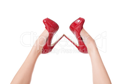 Sexy bare female legs in elegant red stilettos