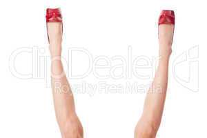 Sexy bare female legs in elegant red stilettos