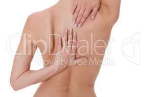 Woman caressing her bare shoulder and back