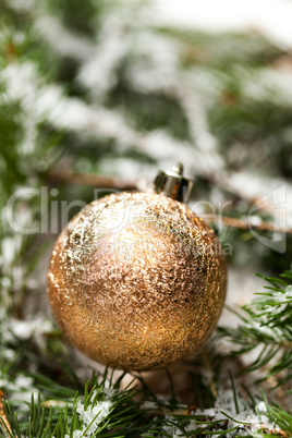 Gold Christmas ornament on leaves