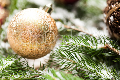 Gold Christmas ornament on leaves