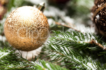 Gold Christmas ornament on leaves