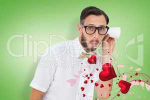 Composite image of geeky businessman eavesdropping with cup