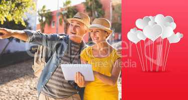 Composite image of happy tourist couple using tablet pc in the c