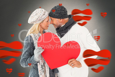 Composite image of smiling couple in winter fashion posing with