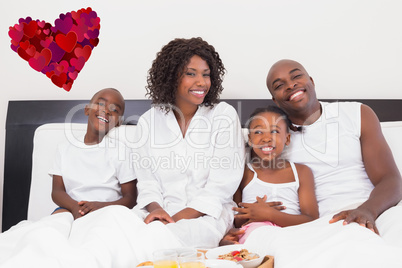 Composite image of happy family having breakfast in bed