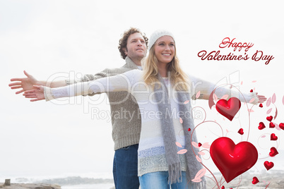 Composite image of happy casual young couple stretching hands ou