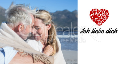 Composite image of smiling couple sitting on the beach under bla
