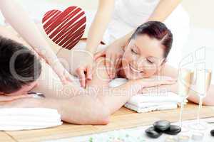 Composite image of positive young couple enjoying a back massage