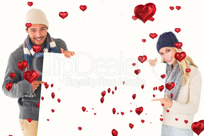 Composite image of attractive couple in winter fashion showing p